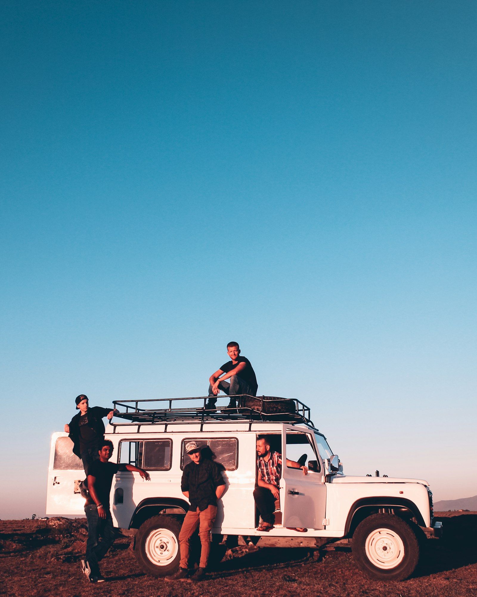 Young travelers on a group roadtrip at golden hour